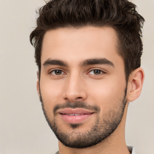 Joyful white young-adult male with short  black hair and brown eyes