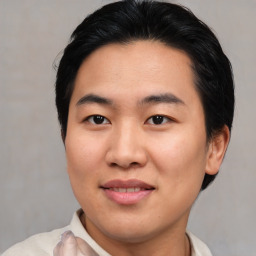 Joyful asian young-adult male with short  brown hair and brown eyes