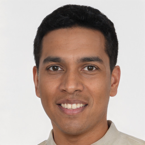 Joyful latino young-adult male with short  black hair and brown eyes