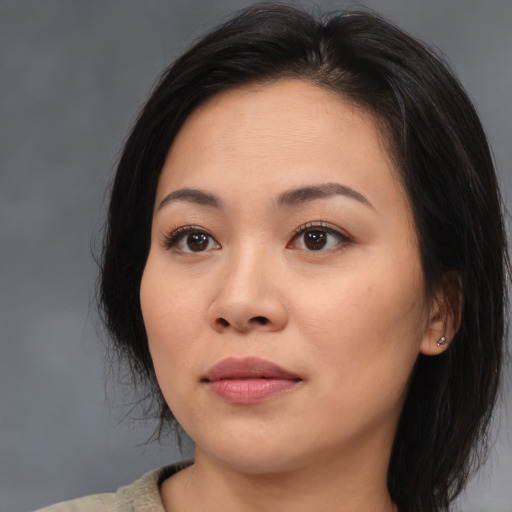 Joyful asian young-adult female with medium  brown hair and brown eyes