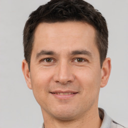 Joyful white adult male with short  brown hair and brown eyes