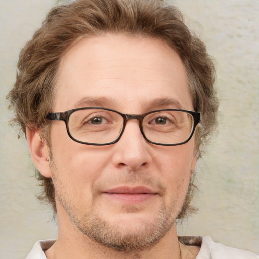 Joyful white adult male with short  brown hair and green eyes