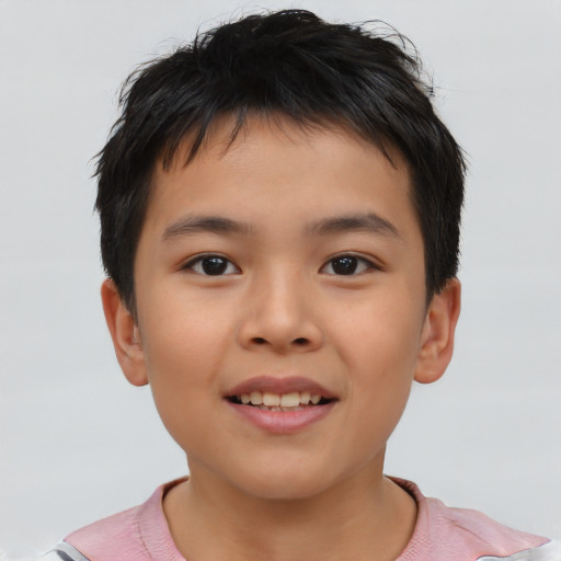 Joyful asian child male with short  brown hair and brown eyes