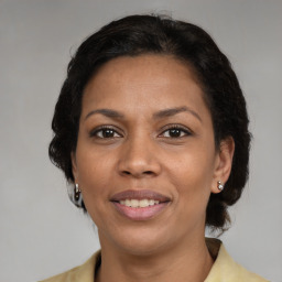 Joyful latino adult female with medium  brown hair and brown eyes