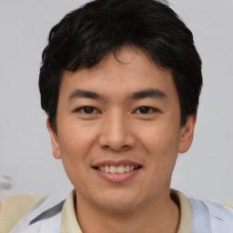 Joyful asian young-adult male with short  brown hair and brown eyes