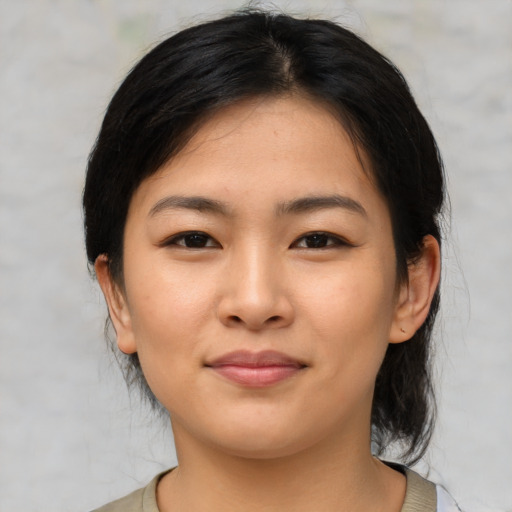 Joyful asian young-adult female with medium  brown hair and brown eyes