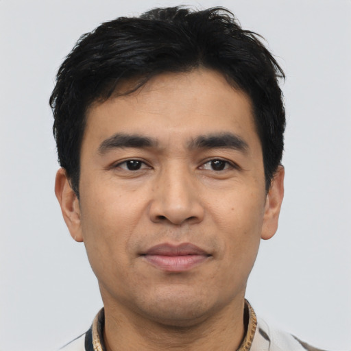Joyful asian young-adult male with short  black hair and brown eyes