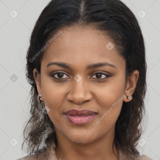 Joyful black young-adult female with long  brown hair and brown eyes