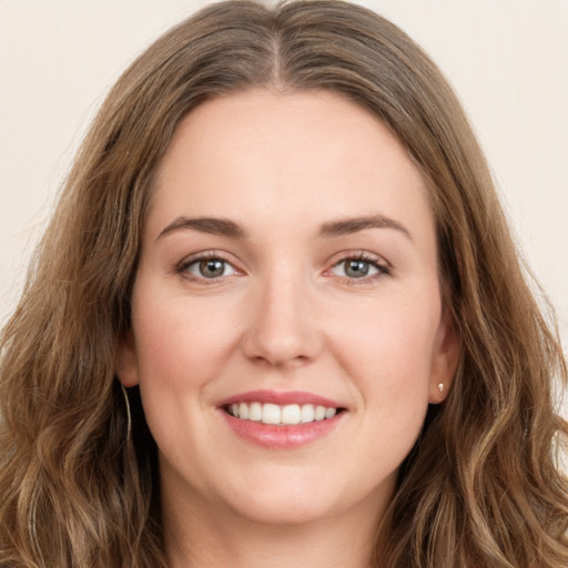 Joyful white young-adult female with long  brown hair and green eyes