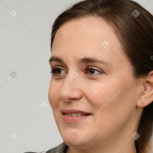 Joyful white adult female with long  brown hair and grey eyes