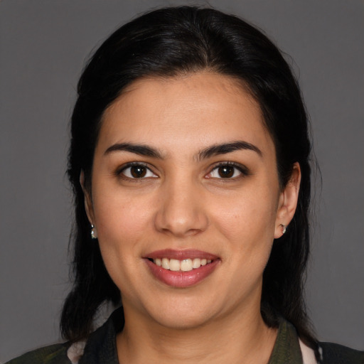 Joyful latino young-adult female with medium  black hair and brown eyes