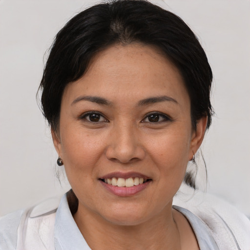 Joyful white young-adult female with medium  black hair and brown eyes