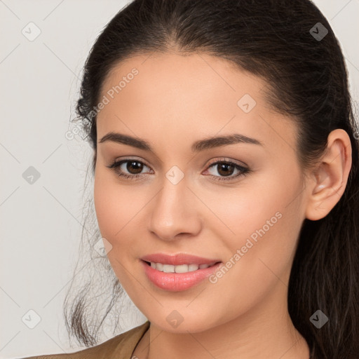 Joyful white young-adult female with long  brown hair and brown eyes