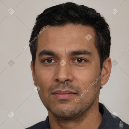 Neutral latino young-adult male with short  black hair and brown eyes