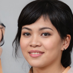 Joyful asian young-adult female with medium  black hair and brown eyes