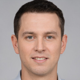 Joyful white young-adult male with short  brown hair and brown eyes