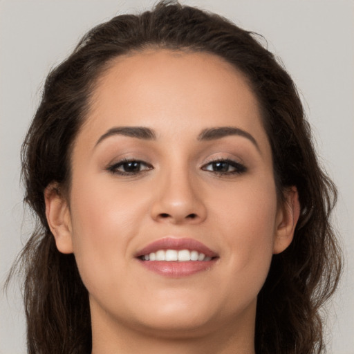 Joyful white young-adult female with long  brown hair and brown eyes