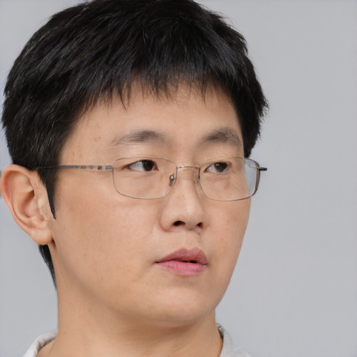 Neutral asian young-adult male with short  brown hair and brown eyes