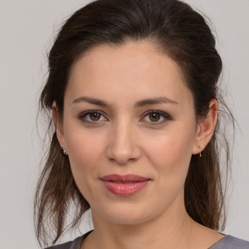 Joyful white young-adult female with medium  brown hair and brown eyes