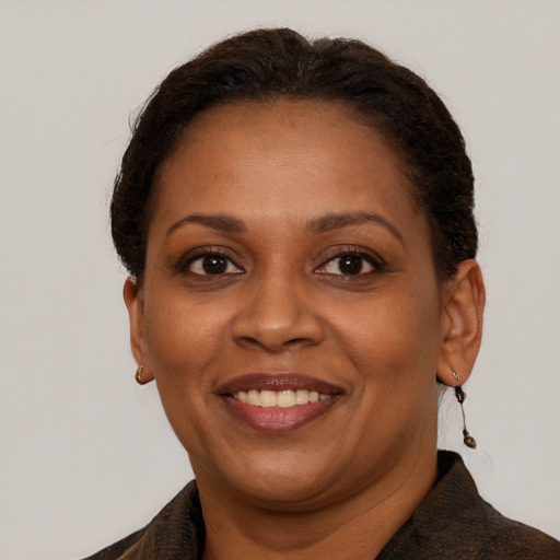 Joyful black adult female with short  brown hair and brown eyes