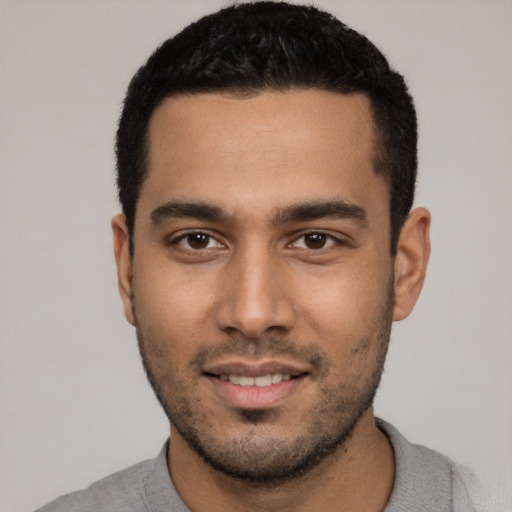 Joyful white young-adult male with short  black hair and brown eyes