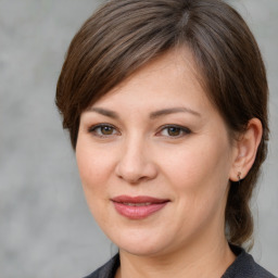 Joyful white young-adult female with medium  brown hair and grey eyes