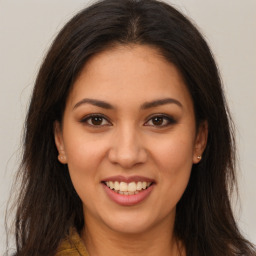 Joyful latino young-adult female with long  brown hair and brown eyes