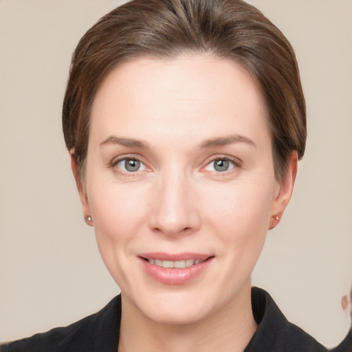 Joyful white young-adult female with short  brown hair and grey eyes