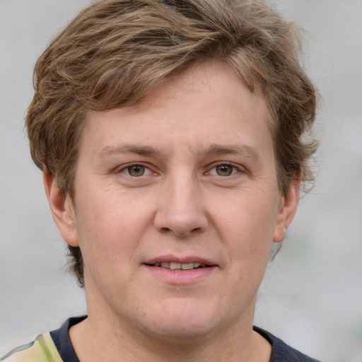 Joyful white adult male with short  brown hair and grey eyes