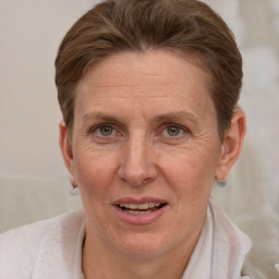 Joyful white adult female with short  brown hair and brown eyes