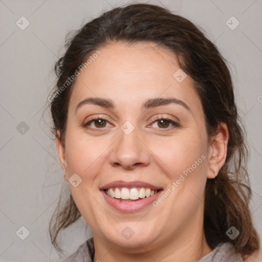 Joyful white adult female with medium  brown hair and brown eyes