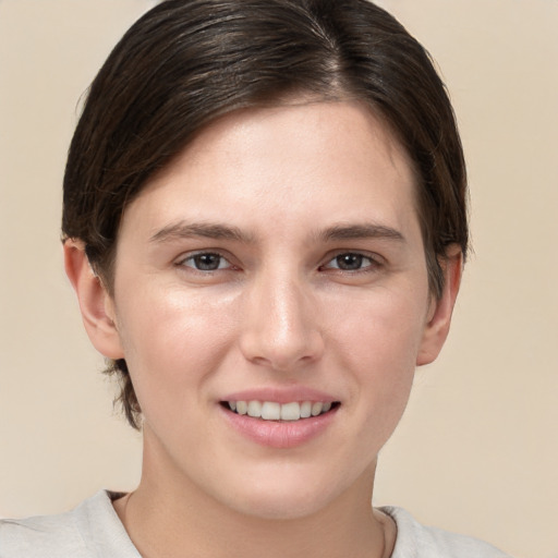 Joyful white young-adult female with short  brown hair and brown eyes