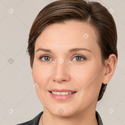 Joyful white young-adult female with medium  brown hair and grey eyes