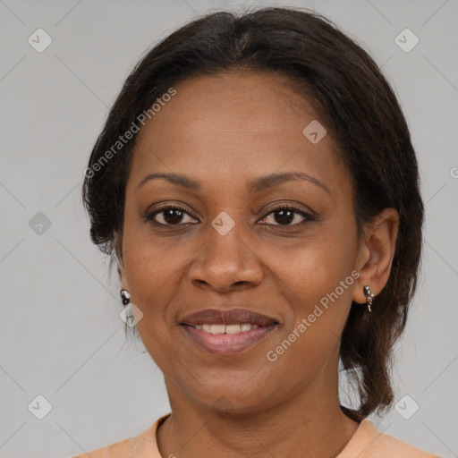 Joyful black adult female with medium  brown hair and brown eyes