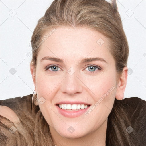Joyful white young-adult female with long  brown hair and blue eyes