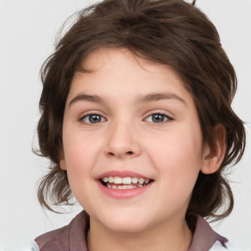 Joyful white child female with medium  brown hair and brown eyes