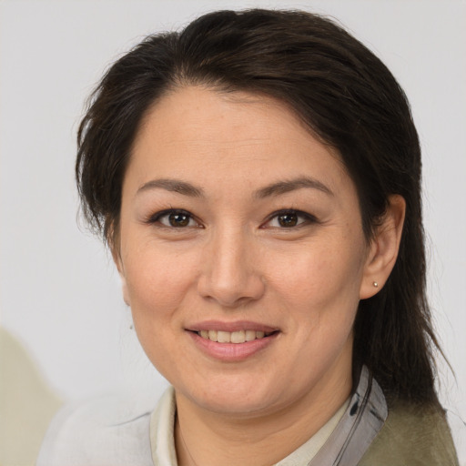 Joyful white adult female with medium  brown hair and brown eyes