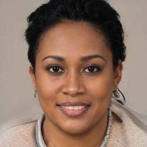 Joyful black young-adult female with short  brown hair and brown eyes