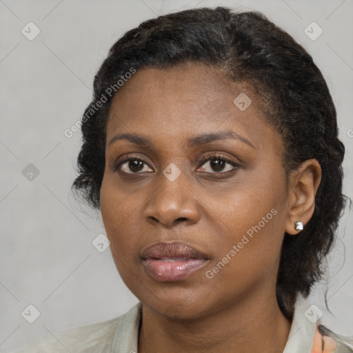 Joyful black adult female with medium  brown hair and brown eyes