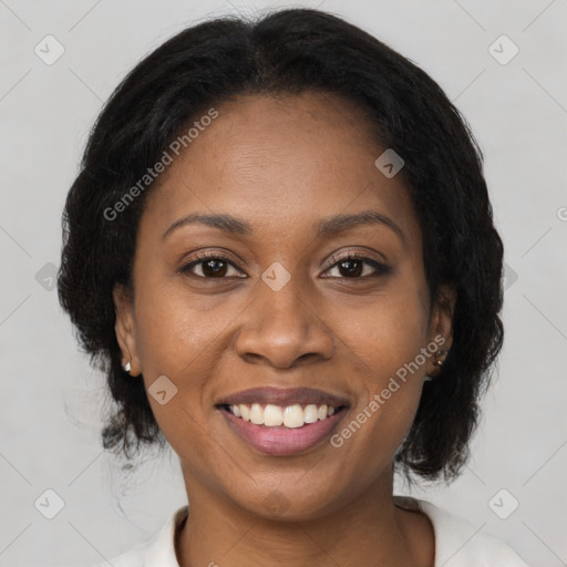 Joyful black adult female with medium  brown hair and brown eyes