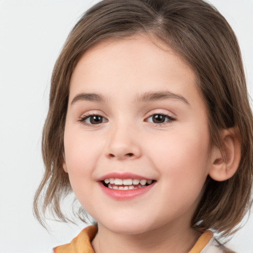 Joyful white child female with medium  brown hair and brown eyes