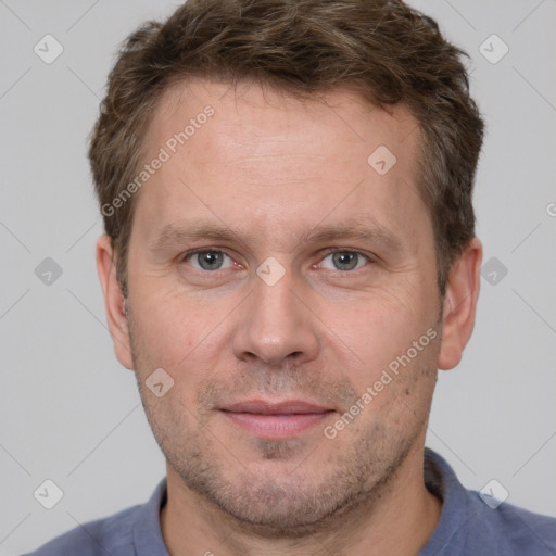 Joyful white adult male with short  brown hair and grey eyes