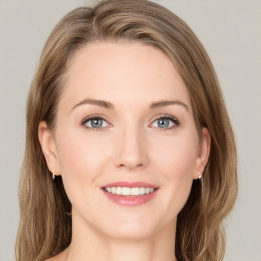 Joyful white young-adult female with long  brown hair and grey eyes