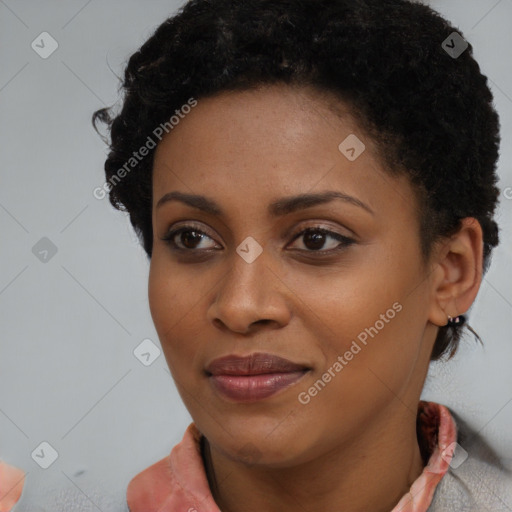 Joyful black young-adult female with short  black hair and brown eyes