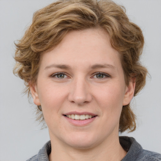 Joyful white young-adult female with medium  brown hair and blue eyes