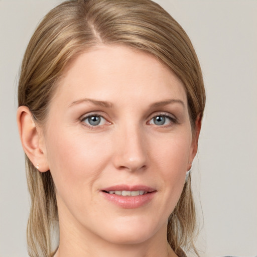 Joyful white young-adult female with long  brown hair and blue eyes