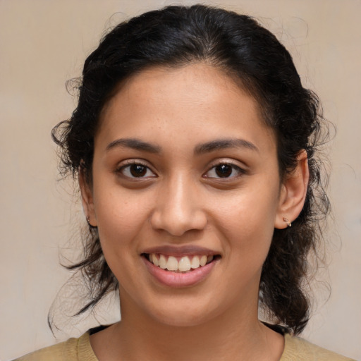 Joyful latino young-adult female with medium  brown hair and brown eyes