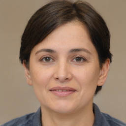 Joyful white adult female with medium  brown hair and brown eyes