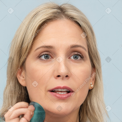 Joyful white adult female with long  brown hair and grey eyes