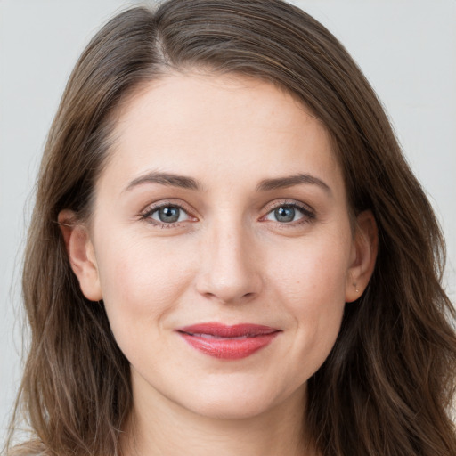 Joyful white young-adult female with long  brown hair and grey eyes